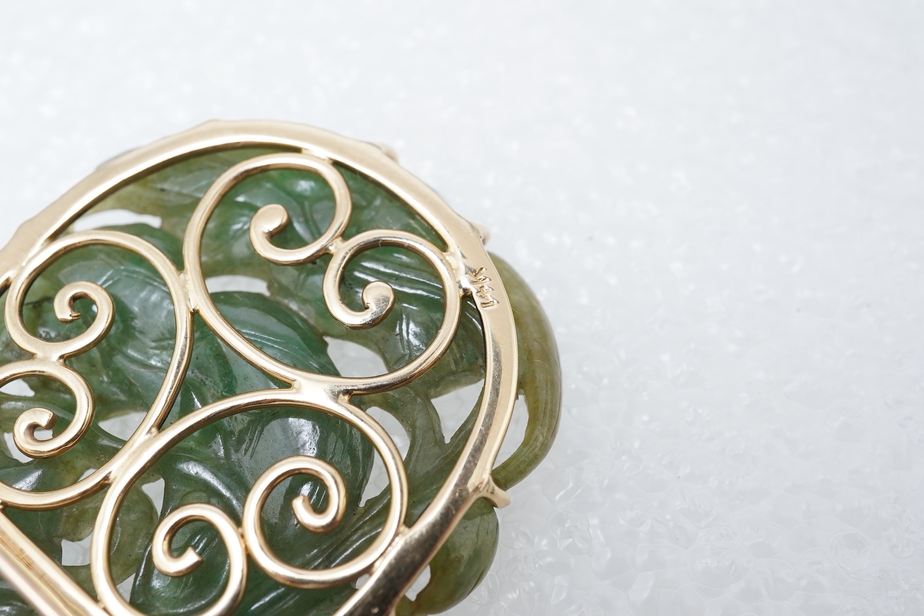 A carved jadeite brooch/pendant